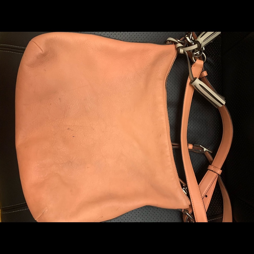 Peach color Coach purse. No rips or tears. Gorgeous purse. Must have for summer.